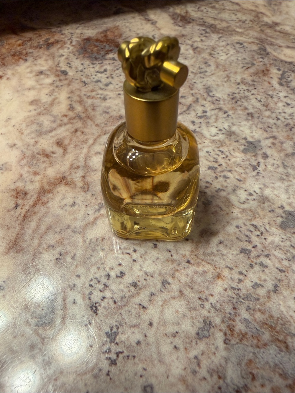Bottega Veneta Clear Glass Perfume Bottle with Gold Cap and Amber Liquid